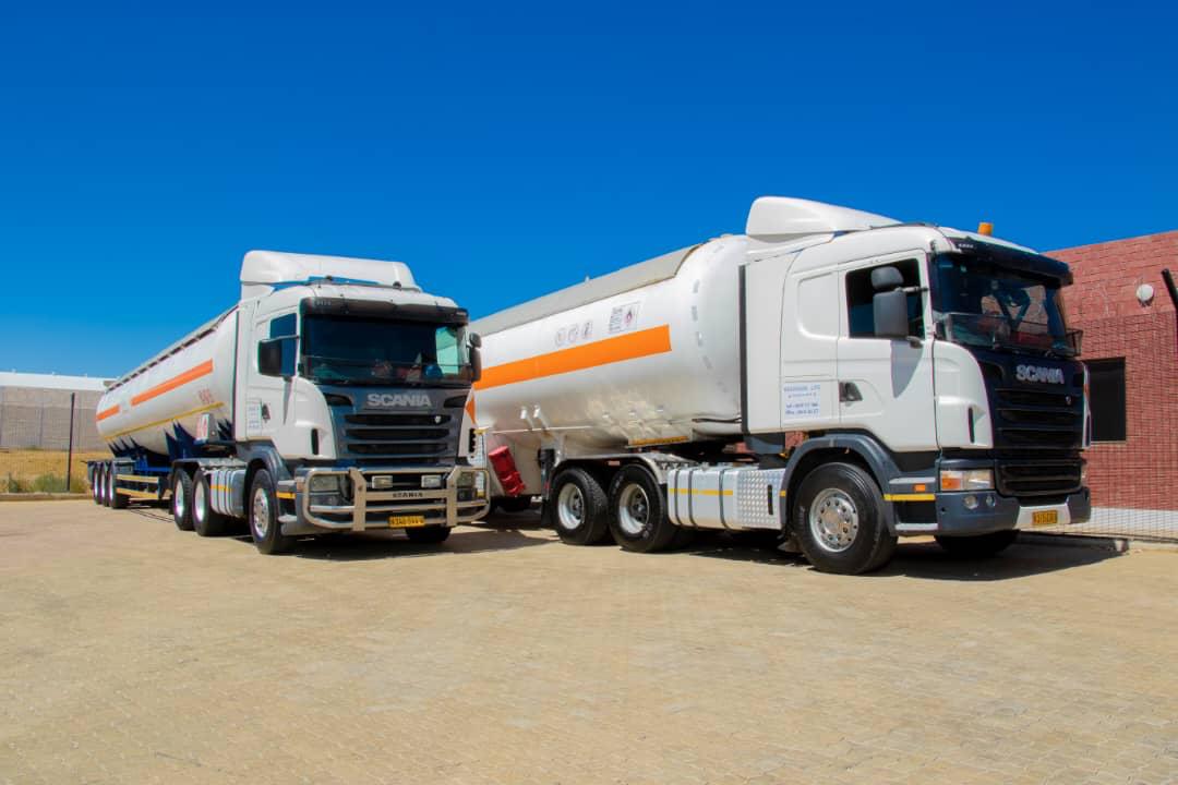 Two Scania tanker trucks parked at depot
