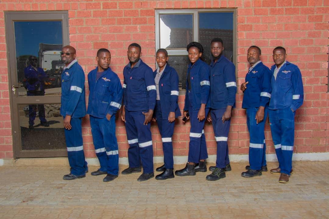 Branch and depot crew lined up against a brick wall