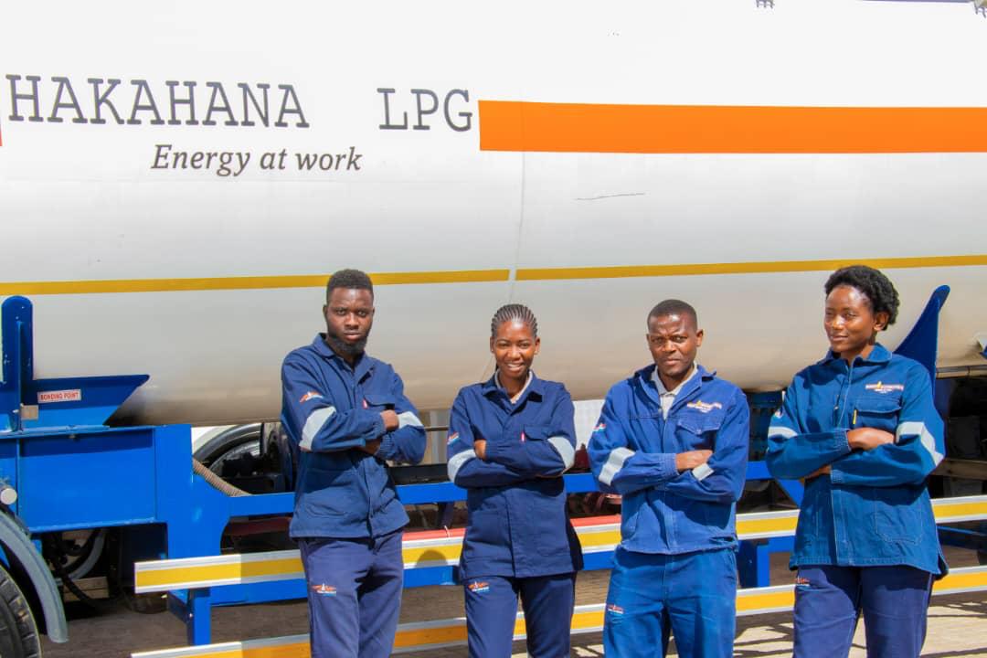 Logistics crew posed in front of tanker